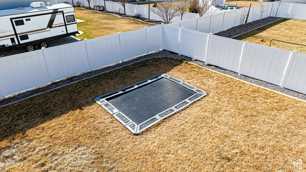 Exterior space featuring a lawn and a fenced backyard