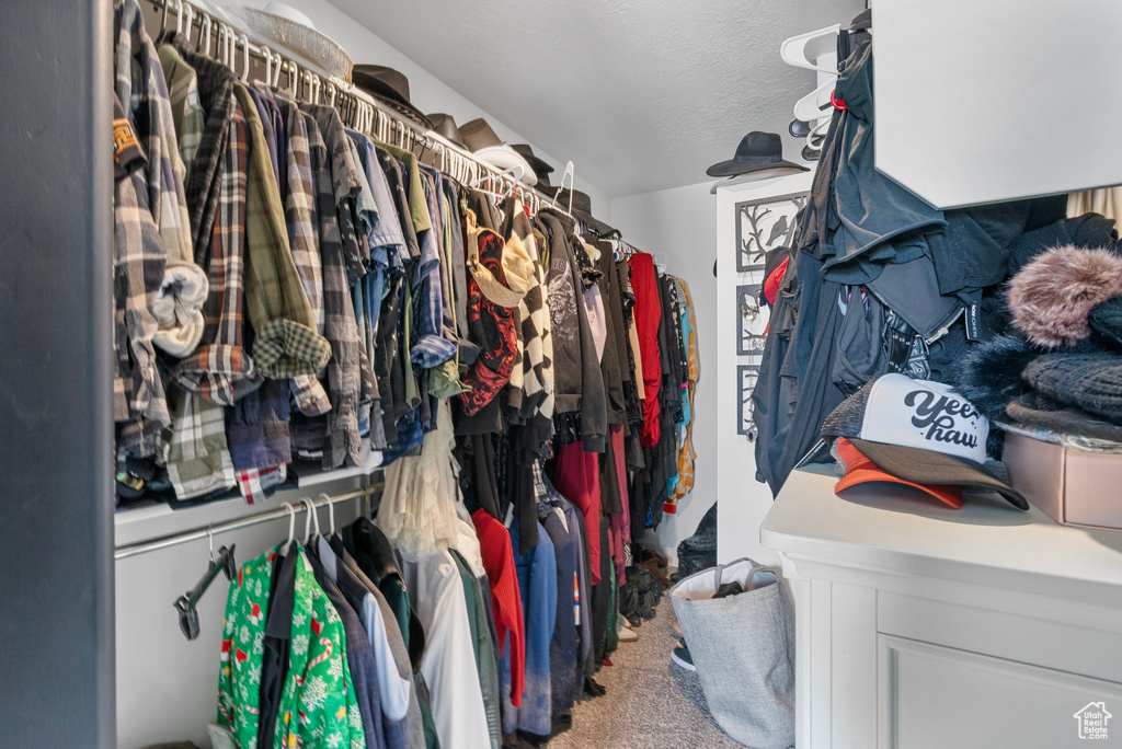 Walk in closet featuring carpet flooring