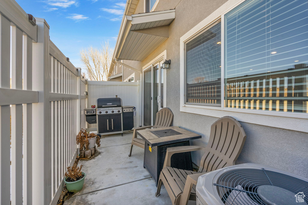 View of patio / terrace featuring central AC unit, fence, and area for grilling