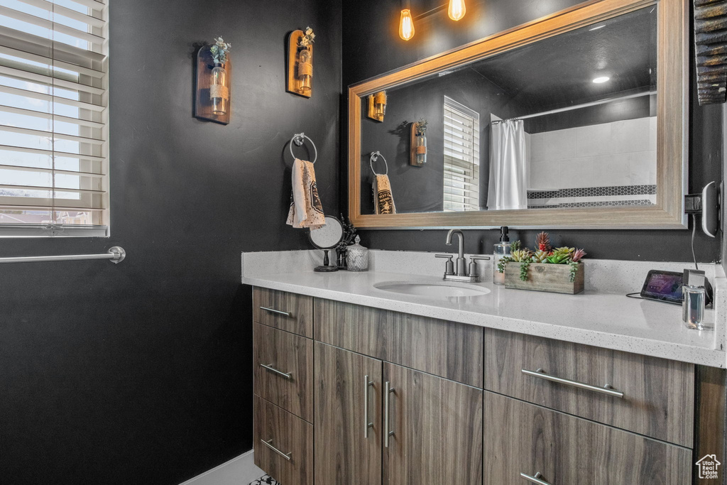 Full bath featuring vanity and a shower with curtain
