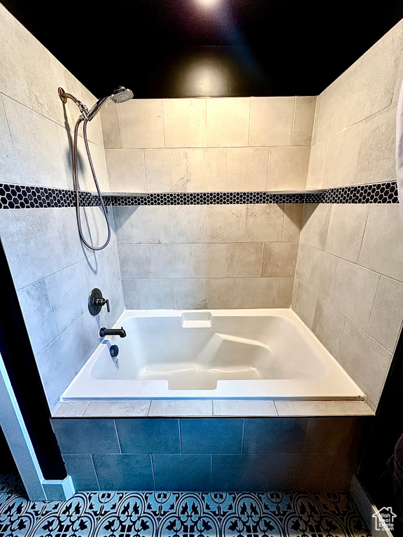 Bathroom with tiled shower / bath and tile patterned flooring