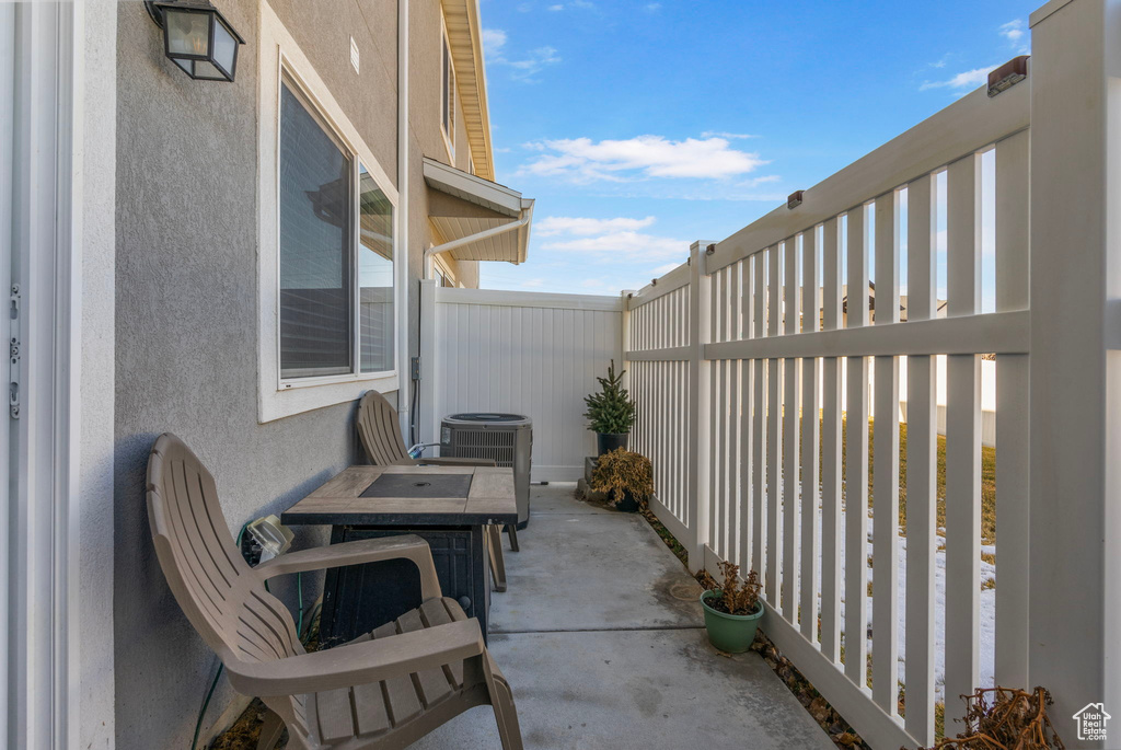 View of patio / terrace with central AC unit and fence