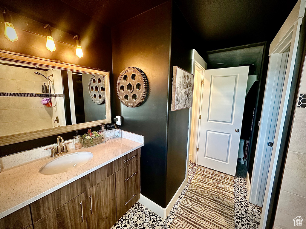Bathroom featuring tile patterned flooring and vanity