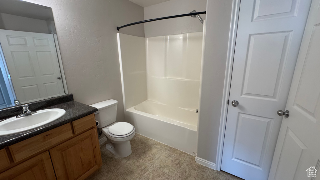 Bathroom featuring vanity, a textured wall, and tub / shower combination