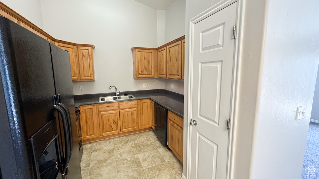 Kitchen with black appliances and dark countertops