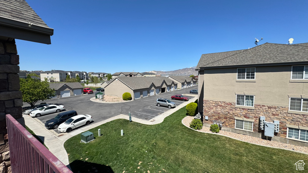 Exterior space with a residential view, uncovered parking, and a yard