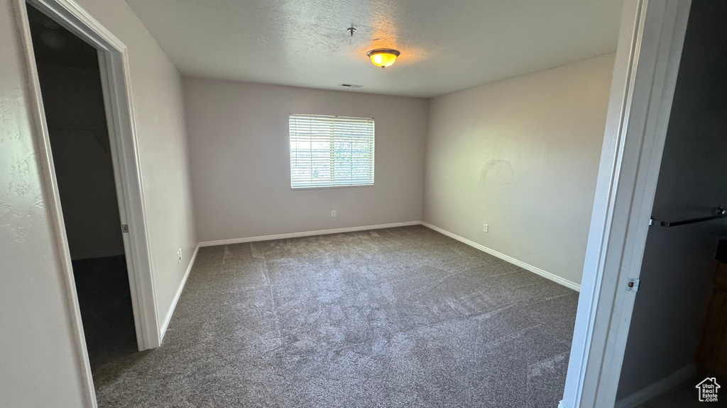 Unfurnished bedroom with carpet flooring and baseboards