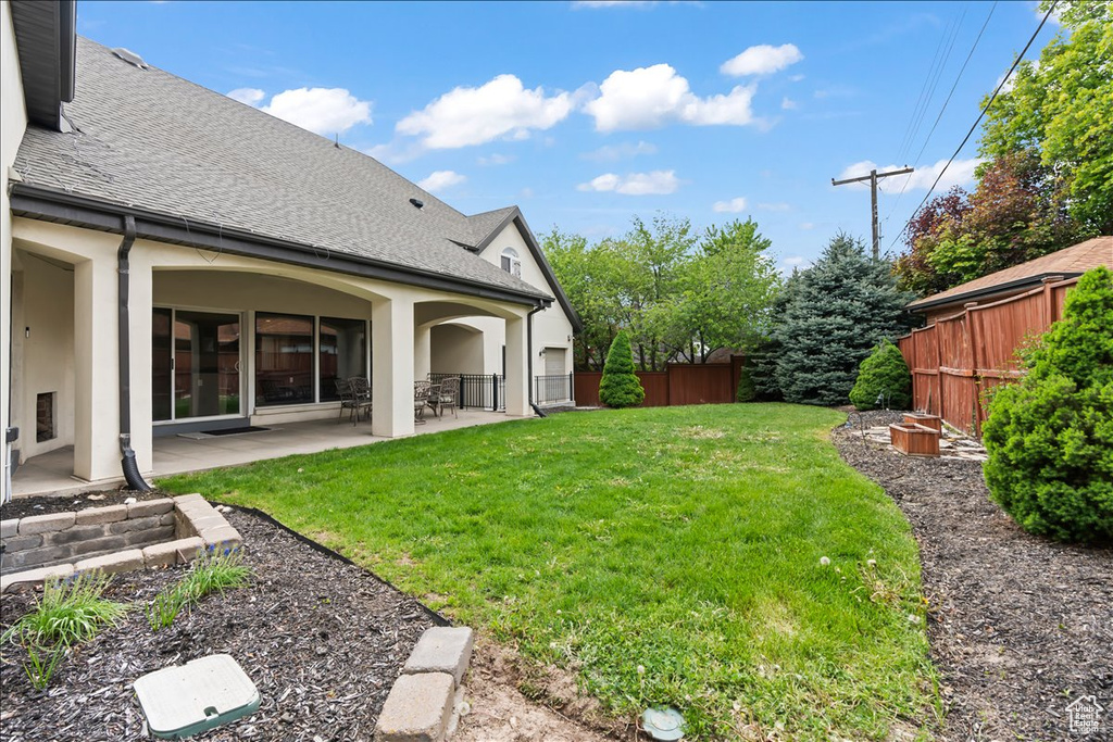 View of yard featuring a fenced backyard and a patio area