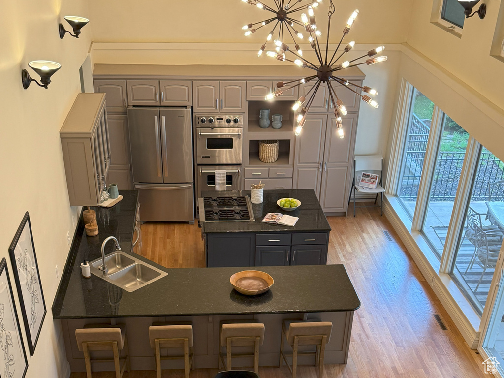 Dining area featuring a chandelier, baseboards, light wood-type flooring, and visible vents