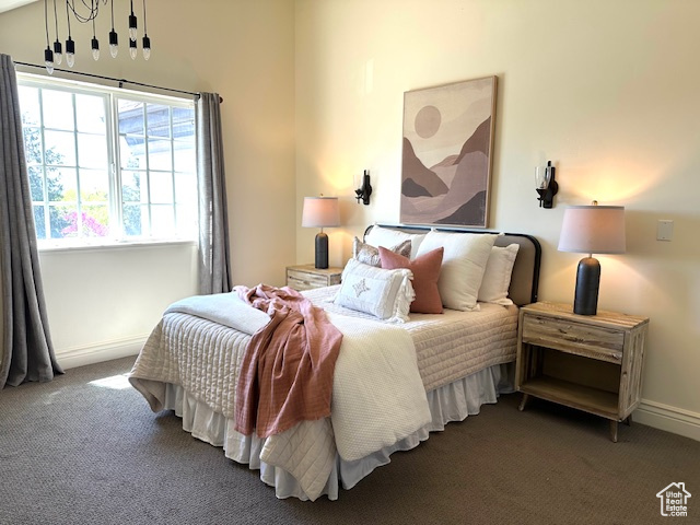 Bedroom with baseboards and carpet