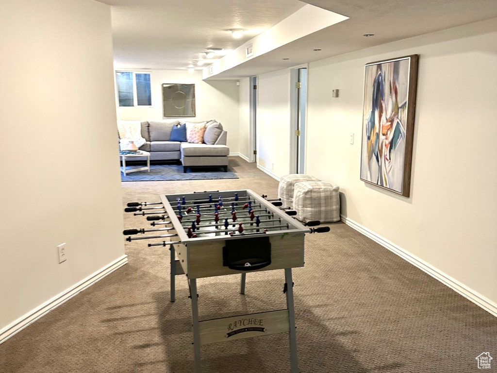 Recreation room featuring carpet floors and baseboards