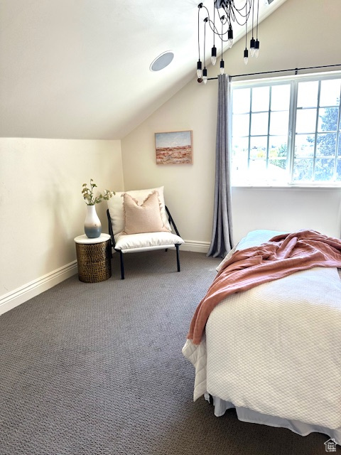 Bedroom with baseboards, vaulted ceiling, and carpet flooring