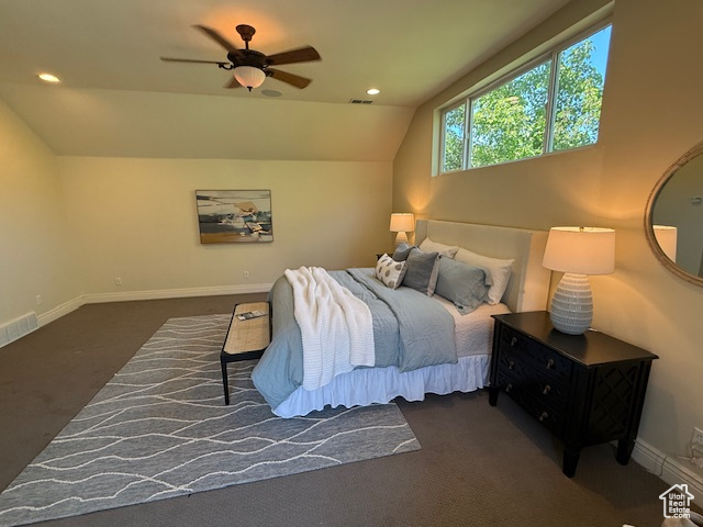 Carpeted bedroom with visible vents, baseboards, ceiling fan, and vaulted ceiling