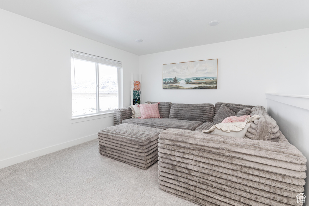 Living room with baseboards and light colored carpet