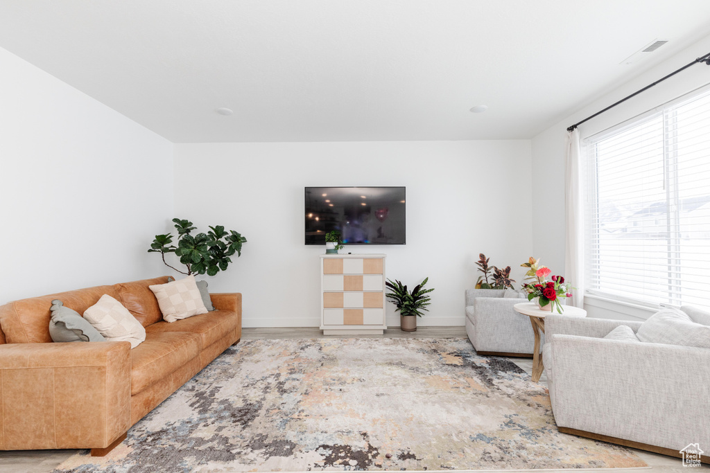 Living area with baseboards and wood finished floors
