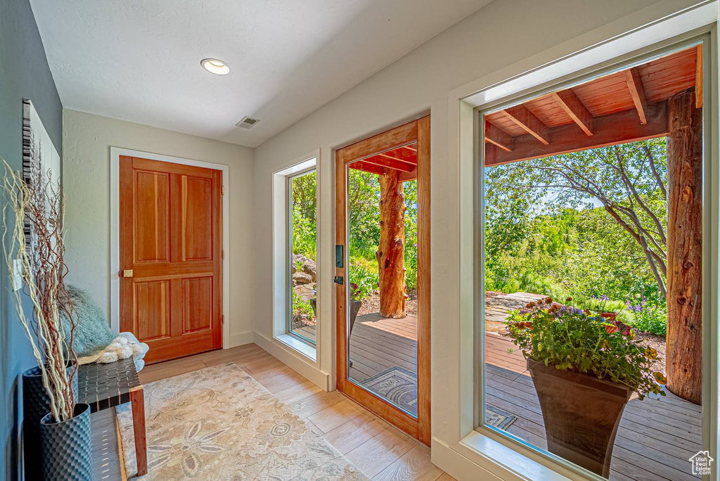 Foyer entrance with light wood-type flooring, recessed lighting, and baseboards
