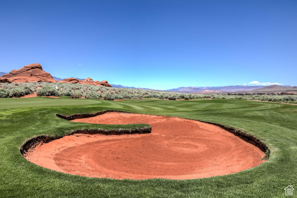 Surrounding community with a mountain view, golf course view, and a lawn