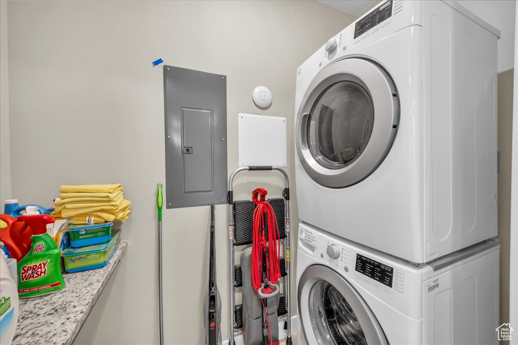 Laundry area with stacked washer and dryer, laundry area, and electric panel