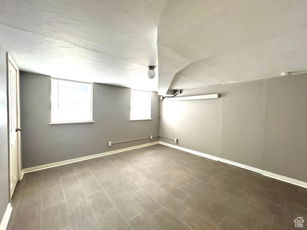 Below grade area featuring a textured ceiling and baseboards