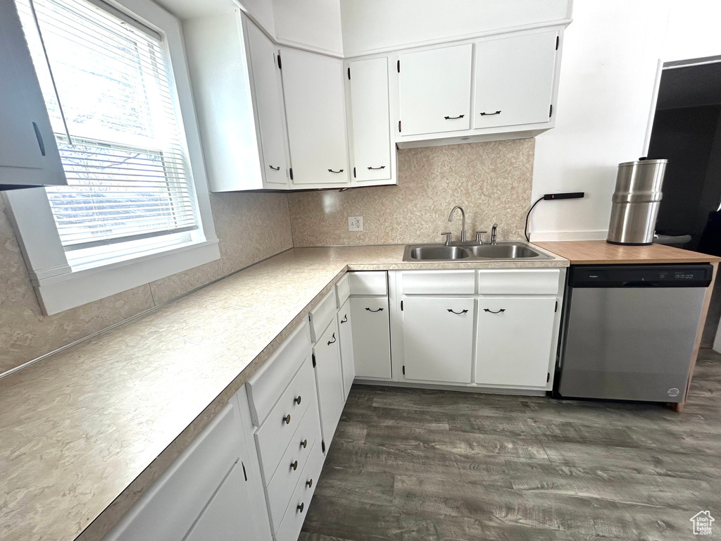 Kitchen with a sink, white cabinetry, dark wood-type flooring, backsplash, and dishwasher
