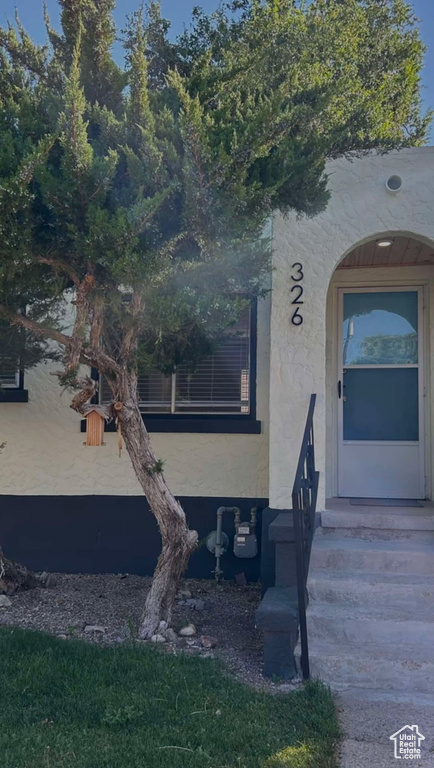 View of exterior entry featuring stucco siding