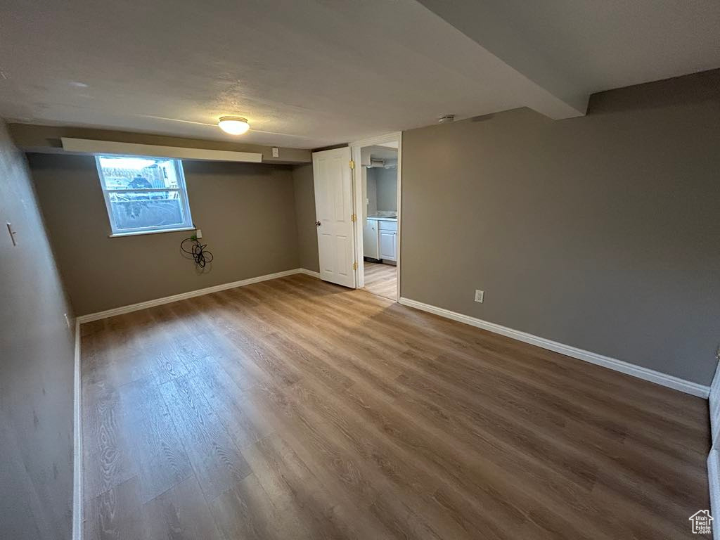 Interior space with baseboards and wood finished floors