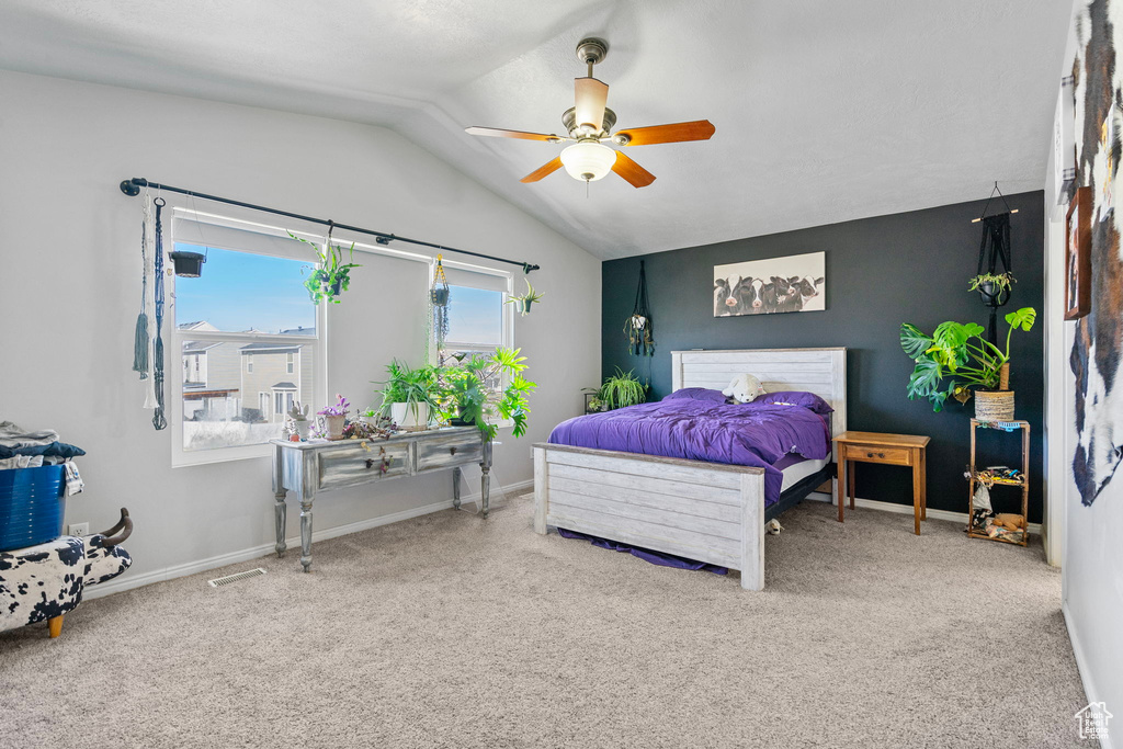 Bedroom with vaulted ceiling, carpet floors, and baseboards