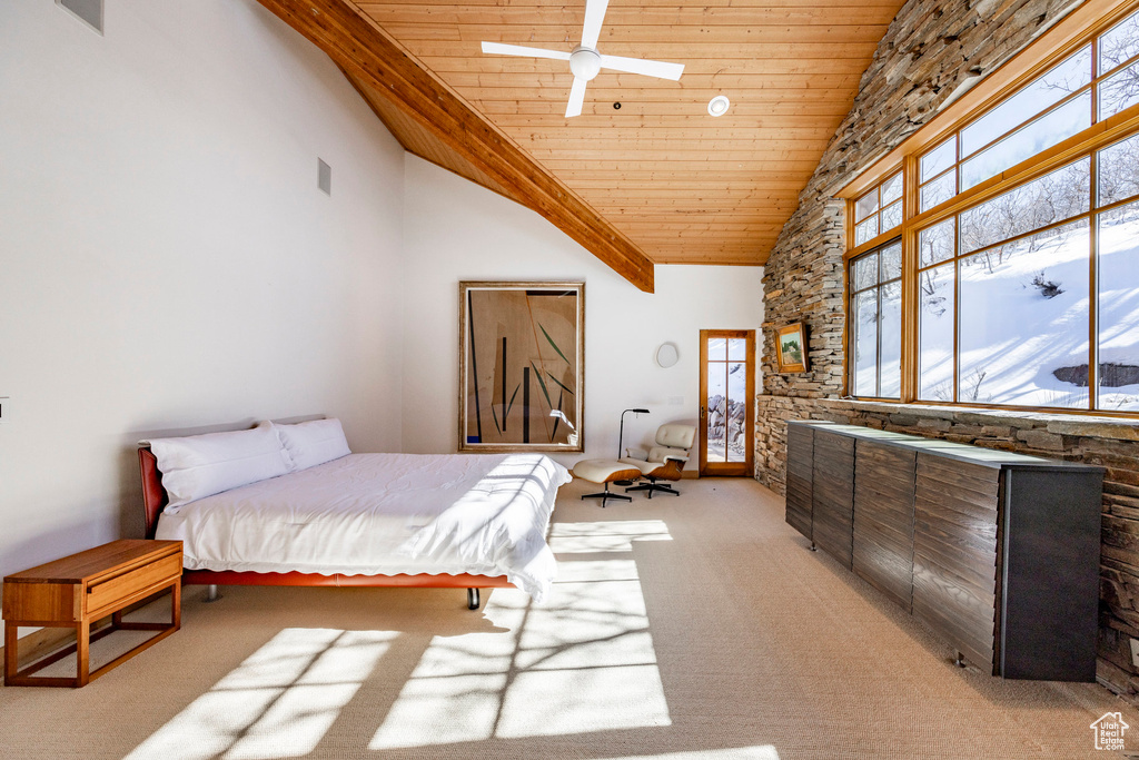 Bedroom featuring wooden ceiling, light colored carpet, and high vaulted ceiling