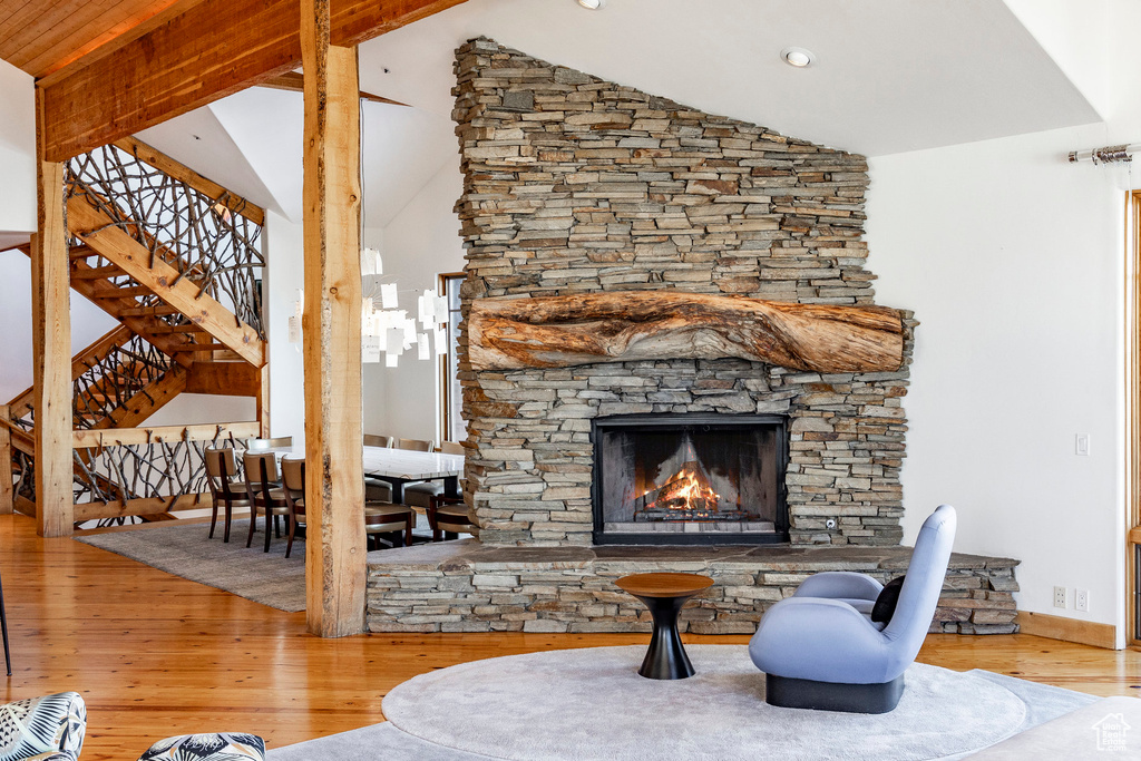 Living area featuring wood finished floors, a fireplace, and stairway