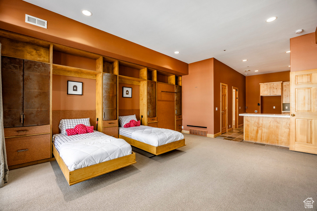 Bedroom with light colored carpet, recessed lighting, and baseboards