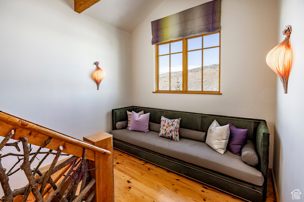 Living room with vaulted ceiling and wood finished floors