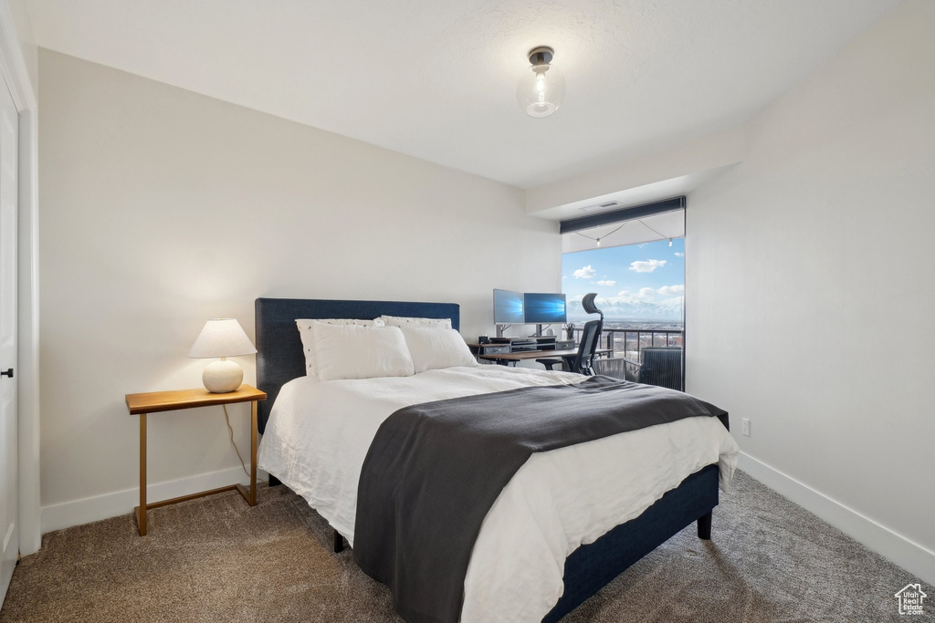 Carpeted bedroom featuring baseboards