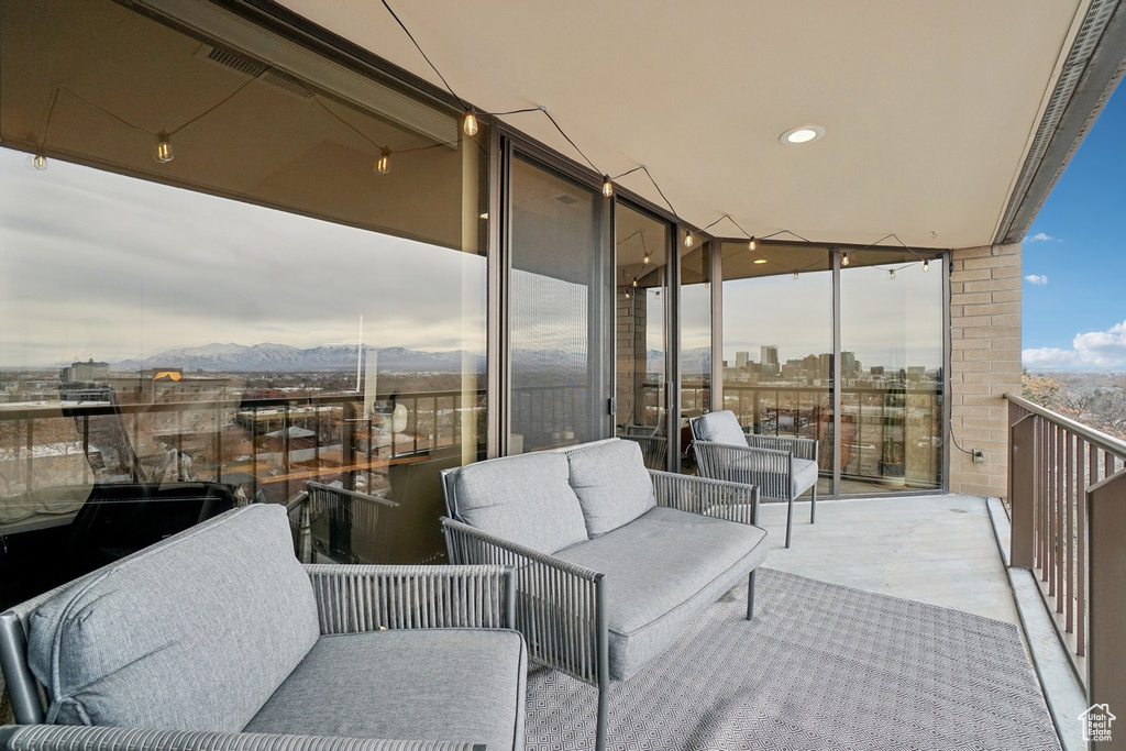 Balcony with a view of city, a mountain view, and outdoor lounge area