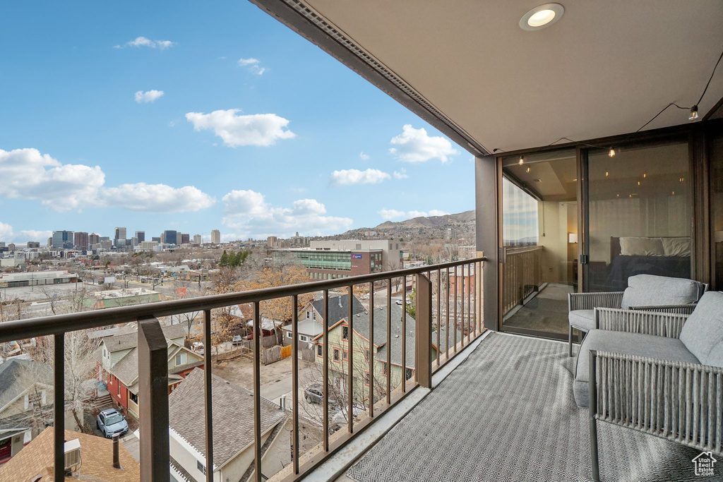 Balcony featuring a mountain view and a city view