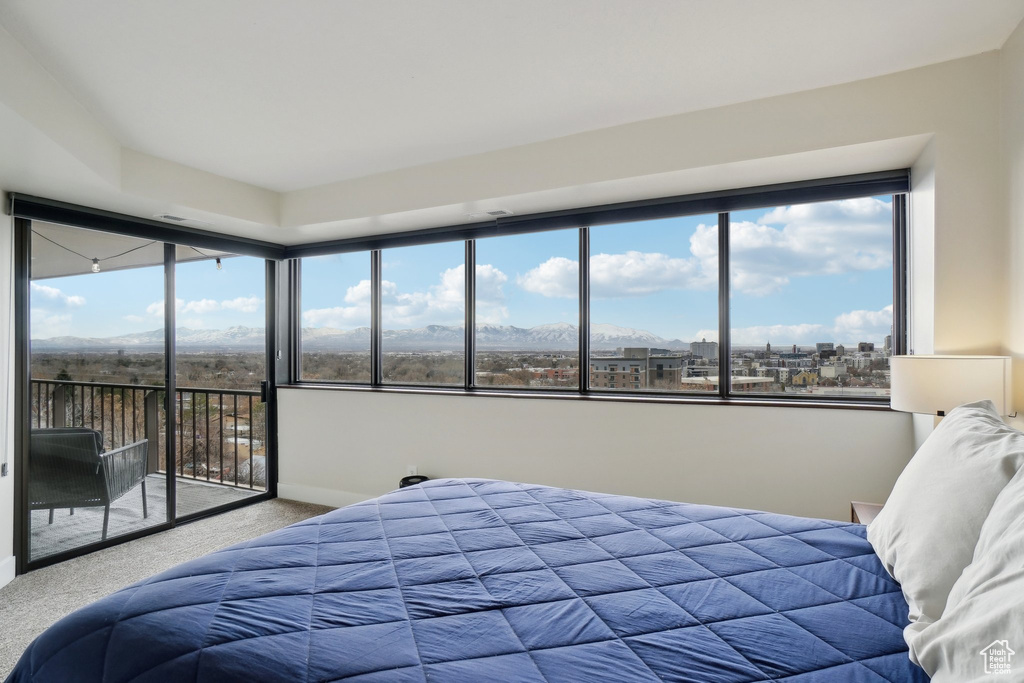 Carpeted bedroom with access to outside and baseboards