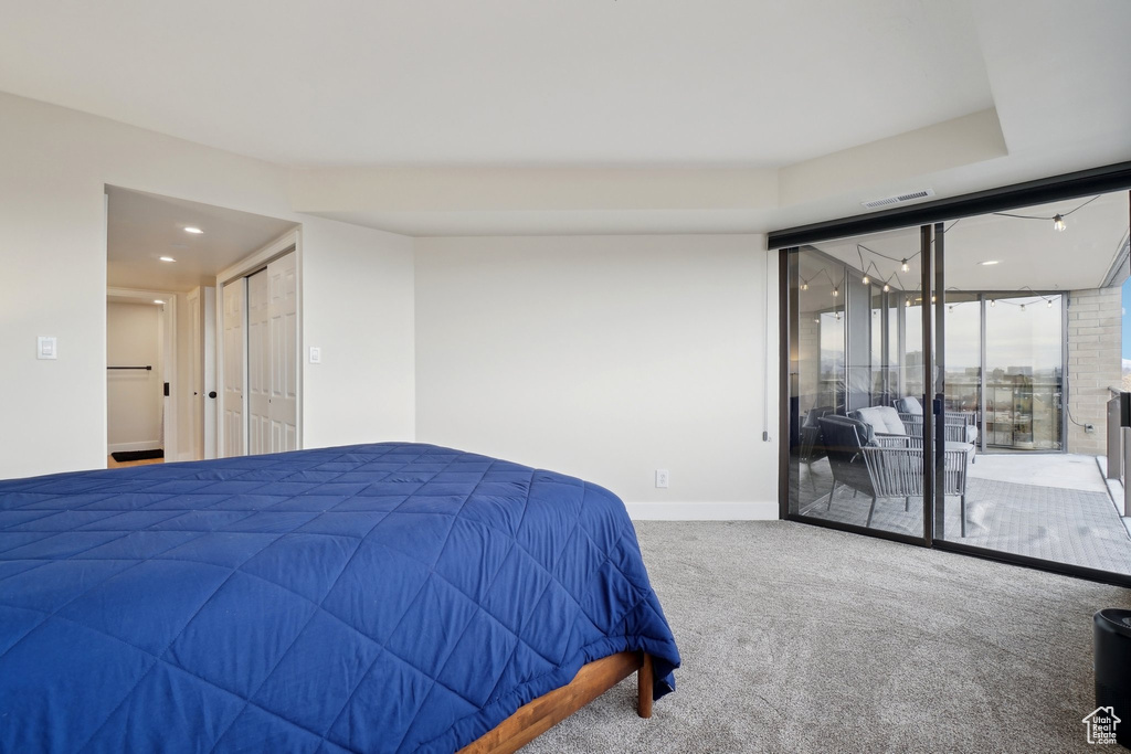 Carpeted bedroom featuring visible vents and baseboards