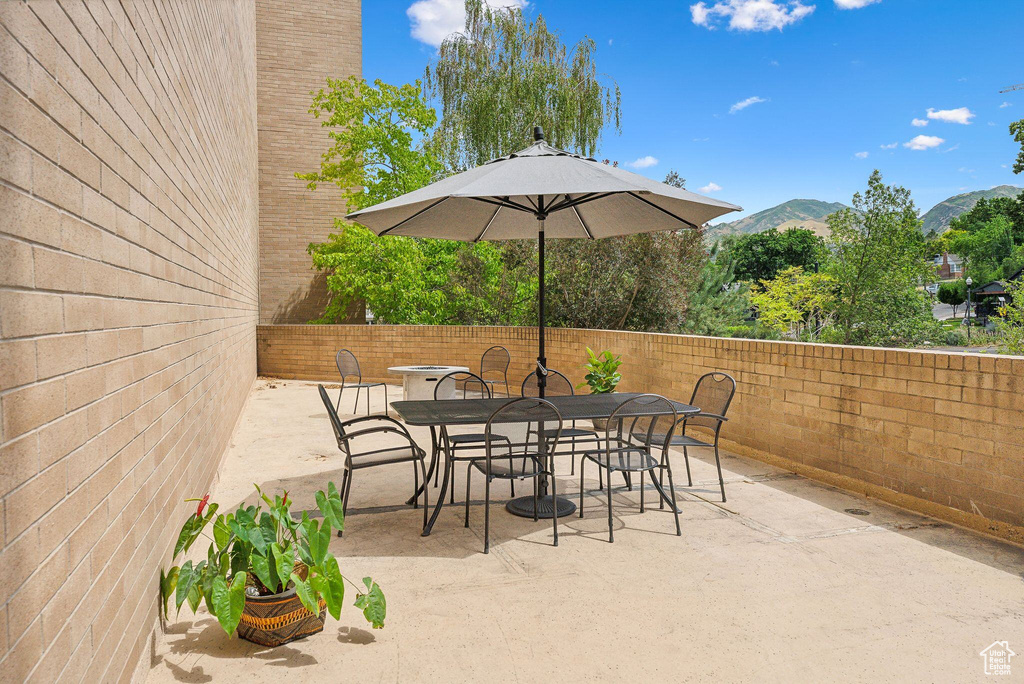 View of patio featuring outdoor dining space, a fenced backyard, and a mountain view