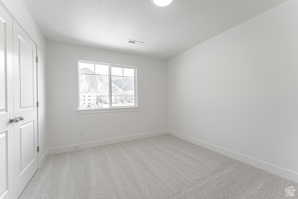 Unfurnished bedroom with carpet and baseboards