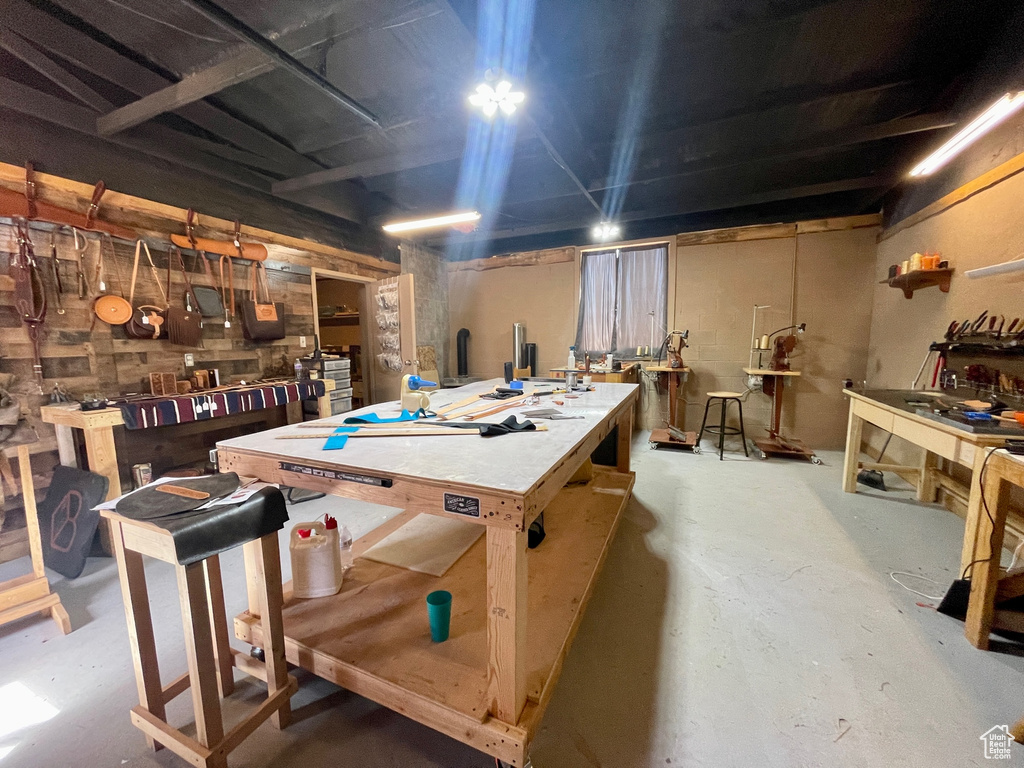 Rec room with concrete floors and a workshop area