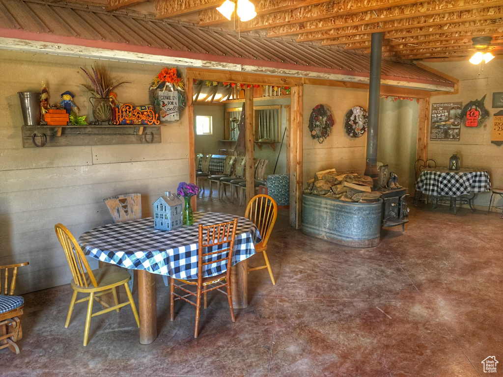 Dining space with a wood stove and concrete floors