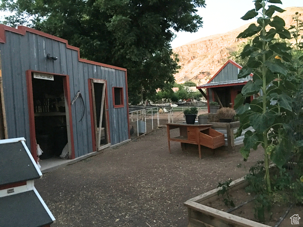 Exterior space featuring a mountain view and an outdoor structure