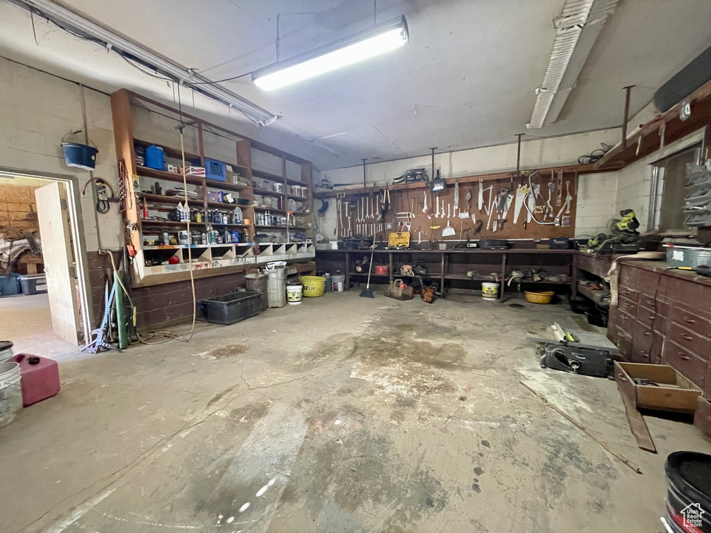 Garage with concrete block wall and a workshop area