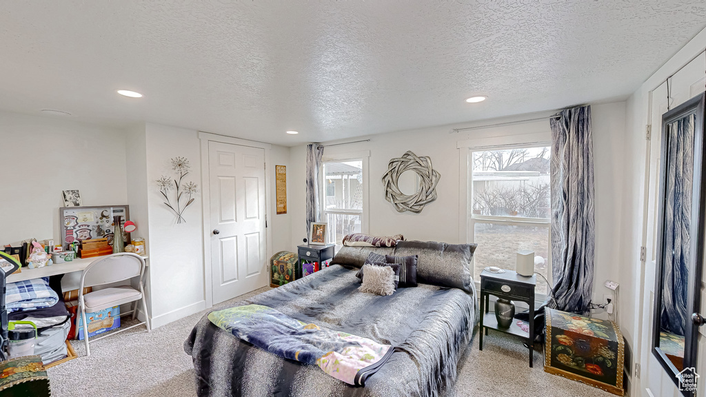 Carpeted bedroom featuring a textured ceiling