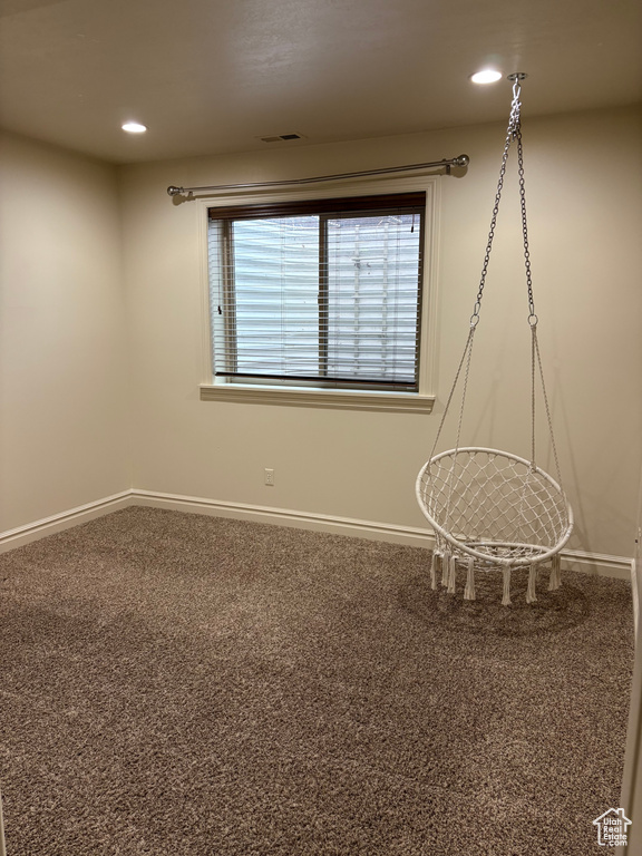 Carpeted spare room featuring recessed lighting, visible vents, and baseboards