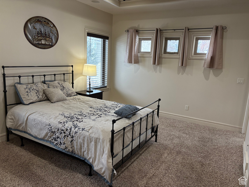 Carpeted bedroom featuring baseboards