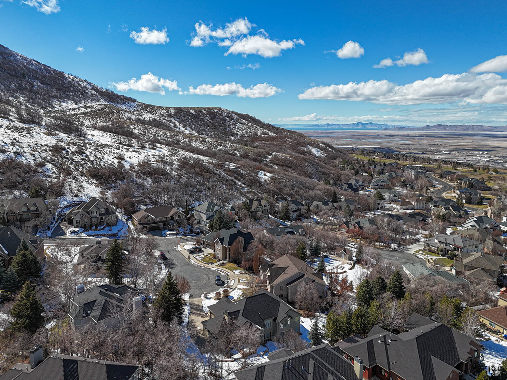 Snowy aerial view featuring a residential view and a mountain view
