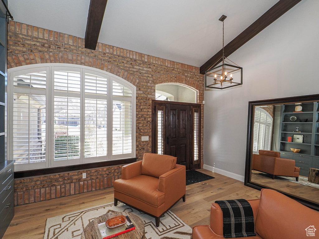 Foyer featuring high vaulted ceiling, a notable chandelier, baseboards, light wood finished floors, and beamed ceiling