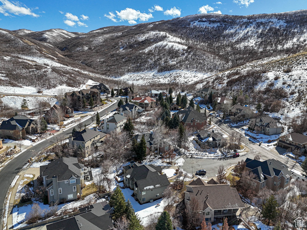 Snowy aerial view featuring a residential view and a mountain view