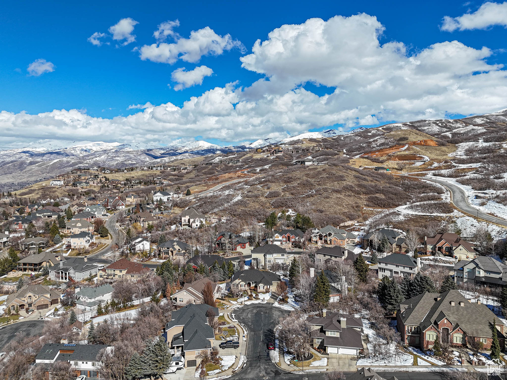 Snowy aerial view featuring a residential view and a mountain view