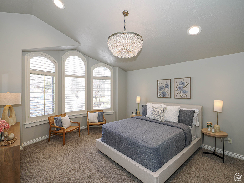 Carpeted bedroom with vaulted ceiling, recessed lighting, baseboards, and an inviting chandelier